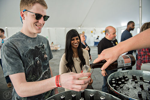 Pete Beegle (left) is poured a sample of beer during the sixth annual Beer Carnival at Atlantic Station in downtown Atlanta on Saturday, March 21, 2015. 