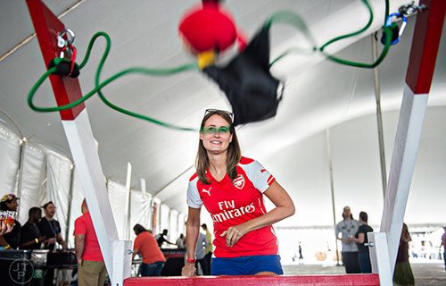 Bethany Laufer launches a stuffed animal into the air with a sling shot during the sixth annual Beer Carnival at Atlantic Station in downtown Atlanta on Saturday, March 21, 2015. 