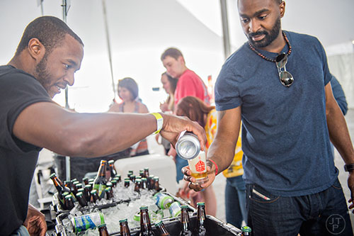 Tyrone Bell (left) pours Reggie Stewart a sample of beer during the sixth annual Beer Carnival at Atlantic Station in downtown Atlanta on Saturday, March 21, 2015. 