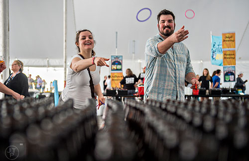 Chelsea Howell (left) and Keith Candeto play a game of ringtoss during the sixth annual Beer Carnival at Atlantic Station in downtown Atlanta on Saturday, March 21, 2015.