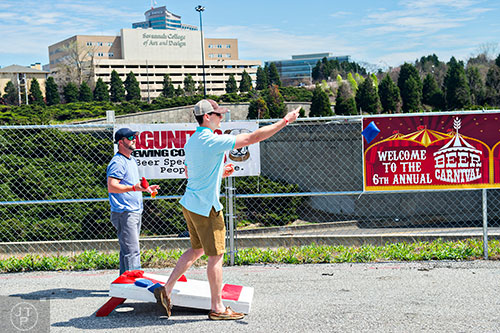 Cam Porter (right) and Brad Dickey play a game of cornhole during the sixth annual Beer Carnival at Atlantic Station in downtown Atlanta on Saturday, March 21, 2015. 