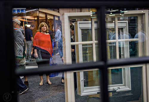 Grace Fry (left) passes by window displays during the 37th annual Spring Atlanta Home Show at the Cobb Galleria Centre in Atlanta on Sunday, March 22, 2015.