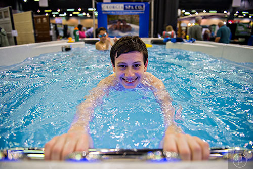 Evan Hirsh demonstrates the ability to swim in a aqua trainer swim spa during the 37th annual Spring Atlanta Home Show at the Cobb Galleria Centre in Atlanta on Sunday, March 22, 2015.