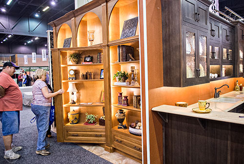 Larry Stafford (left) and his wife Pam look behind a false bookshelf during the 37th annual Spring Atlanta Home Show at the Cobb Galleria Centre in Atlanta on Sunday, March 22, 2015. 