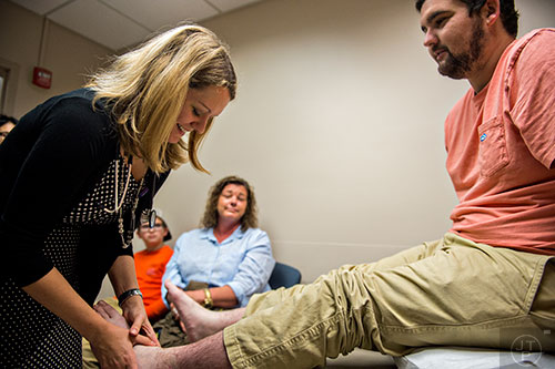 Dr. Heather Gladue (left) checks Drew Crenshaw's pain levels in his legs during his check up at the Emory Clinic off of Clifton Rd. in Atlanta on Friday, March 13, 2015. 