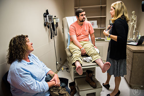 Drew Crenshaw (center) and his mother Melissa Coon talk with Dr. Heather Gladue (right) during his check up at the Emory Clinic off of Clifton Rd. in Atlanta on Friday, March 13, 2015. 