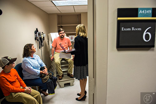 Drew Crenshaw (center), his mother Melissa Coon and younger brother Cooper Coon talk with Dr. Heather Gladue (right) during his check up at the Emory Clinic off of Clifton Rd. in Atlanta on Friday, March 13, 2015. 