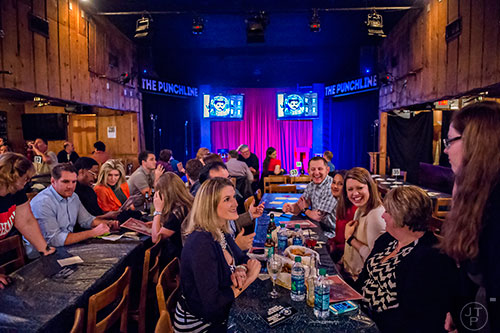 Kristen Abernathy (right) and Charity Reilly (center) talk with friends as they wait for Billy Gardell to take the stage at The Punchline in Atlanta on Friday, March 20, 2015. 