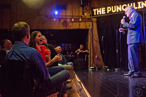 Jennifer Bomar (left) laughs as she watches comedian Dick Kendall open for Billy Gardell at The Punchline in Atlanta on Friday, March 20, 2015. 