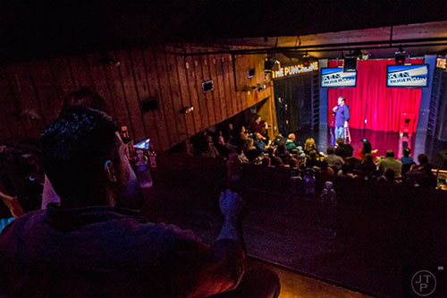 Fans watch comedian Kenny Rogerson perform on stage as he opens for Billy Gardell at The Punchline in Atlanta on Friday, March 20, 2015. 