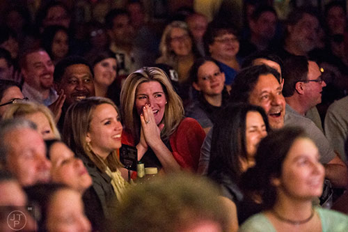 Sarah Tutt (center) laughs as she watches comedian Billy Gardell perform on stage at The Punchline in Atlanta on Friday, March 20, 2015. 