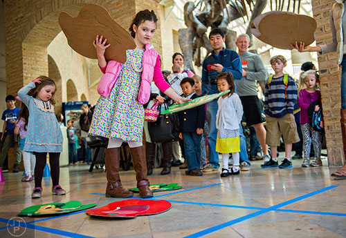 Catherine Schellhammer (center) decides her next move as she plays a game of tic-tac-toe with her sister Charlie during the Spring Egg-stravaganza event at the Fernbank Museum of Natural History in Atlanta on Saturday, March 28, 2015.