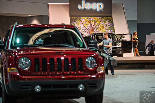 Morgan Copeland (center) checks out the Jeep display during the Atlanta International Auto Show at the Georgia World Congress Center on Sunday, March 29, 2015. 