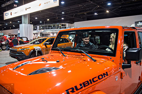 Robin Murray (right) talks to her husband Jeff as they sit inside a Jeep Rubicon during the Atlanta International Auto Show at the Georgia World Congress Center on Sunday, March 29, 2015. 