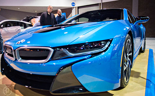Brandon Gant (left) and Robert Grant check out the new BMW i8 during the Atlanta International Auto Show at the Georgia World Congress Center on Sunday, March 29, 2015. 