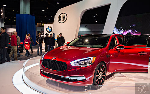 A Kia K900 spins on a display as thousands of people check out the Atlanta International Auto Show at the Georgia World Congress Center on Sunday, March 29, 2015. 