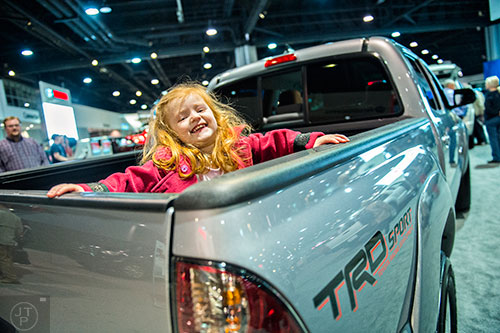 Meredith Koues plays in the bed of a Toyota Tacoma during the Atlanta International Auto Show at the Georgia World Congress Center on Sunday, March 29, 2015. 