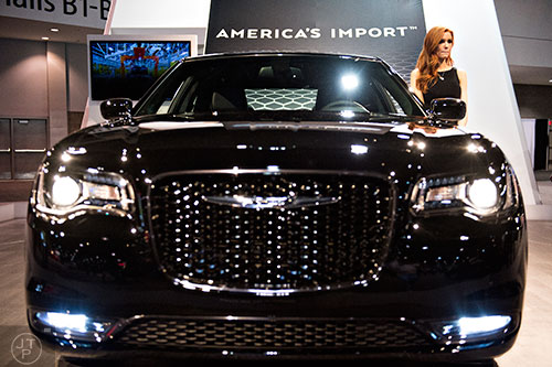 Rae Wawrzyniak models a Chrysler 300S during the Atlanta International Auto Show at the Georgia World Congress Center on Sunday, March 29, 2015. 