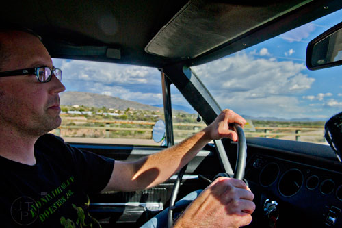 Driving down a desert highway in a Roadrunner.