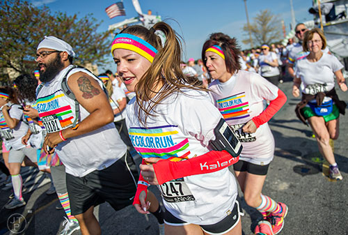 The first wave of racers leave the starting line during The Color Run at Atlanta Motor Speedway in Hampton on Saturday, April 4, 2015. 