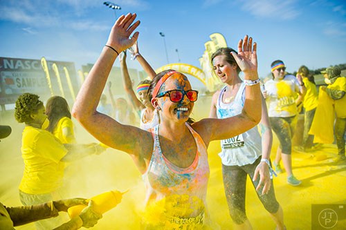 Bianca Cain is covered in yellow colored dust during The Color Run at Atlanta Motor Speedway in Hampton on Saturday, April 4, 2015.