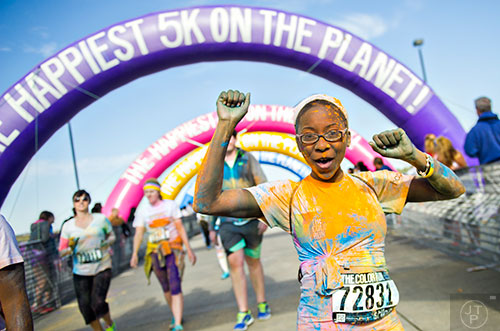 Candace Stanley throws her hands in the air as she crosses the finish line for The Color Run at Atlanta Motor Speedway in Hampton on Saturday, April 4, 2015. 