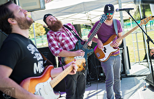 Matt Daniels (left), Logan Daniels and Trey Lander from the band Reuben's Bell perform on stage during the second annual Blue Moon Beltline Boil at the Fourth Ward Skate Park along the Beltline's Eastside Trail in Atlanta on Saturday, April 4, 2015. 