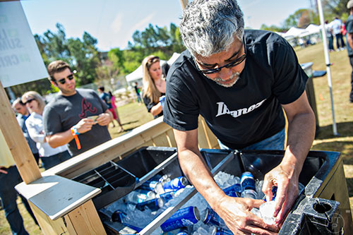 Bobby Danner (right) digs for a cold beer for John Stein during the second annual Blue Moon Beltline Boil at the Fourth Ward Skate Park along the Beltline's Eastside Trail in Atlanta on Saturday, April 4, 2015.