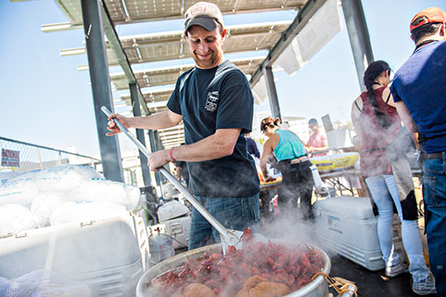 Gary Thorne stirs up a of crawfish during the second annual Blue Moon Beltline Boil at the Fourth Ward Skate Park along the Beltline's Eastside Trail in Atlanta on Saturday, April 4, 2015. 