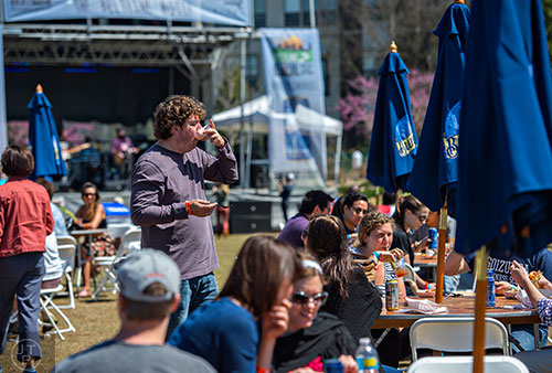 Daniel Sansbury (left) tips back a cup of gumbo during the second annual Blue Moon Beltline Boil at the Fourth Ward Skate Park along the Beltline's Eastside Trail in Atlanta on Saturday, April 4, 2015.