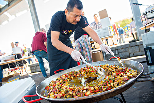 Arnie Hernandez stirs up a pan of fresh cooked food during the second annual Blue Moon Beltline Boil at the Fourth Ward Skate Park along the Beltline's Eastside Trail in Atlanta on Saturday, April 4, 2015.