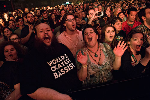 Travis Kilgore (left) and his wife Heather sing along with The Decemberists as they perform on stage at The Tabernacle in Atlanta on Friday, April 10, 2015. 