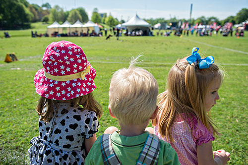 Blakely Ross (left), Daniel Opdycke and his sister Claire watch The Disc Dog Southern Nationals during the 79th annual Atlanta Dogwood Festival at Piedmont Park on Saturday, April 11, 2015.