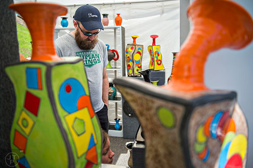 Will Chester (left) checks out Jack Valentine's artwork during the 79th annual Atlanta Dogwood Festival at Piedmont Park on Saturday, April 11, 2015. 