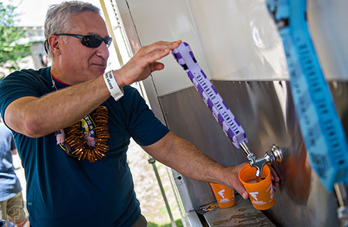 Alan Weissman pours beers during the Hogs & Hops Festival at The Masquerade in Atlanta on Saturday, April 11, 2015.