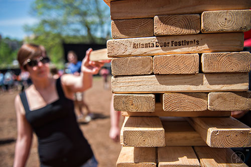 Caitlynn Hoffman plays a game of Jenga during the Hogs & Hops Festival at The Masquerade in Atlanta on Saturday, April 11, 2015.