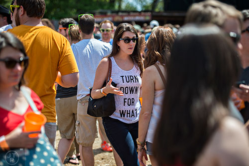 Chelsea Middleton (center) waits in line for a fresh beer while she talks with friends during the Hogs & Hops Festival at The Masquerade in Atlanta on Saturday, April 11, 2015.