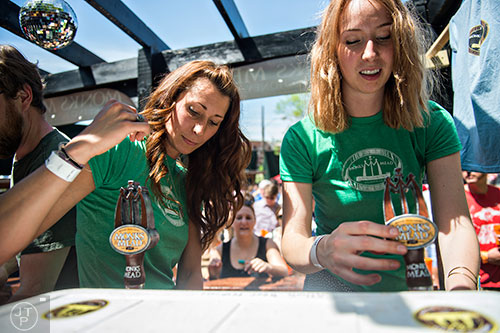 Sarah Pope (left) and Kate Klein pour mead during the Hogs & Hops Festival at The Masquerade in Atlanta on Saturday, April 11, 2015.