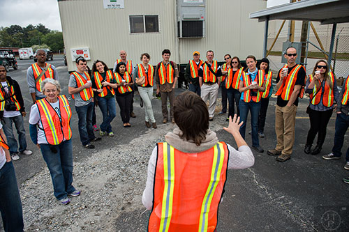 A group of photographers are given instructions and guidelines by Emily Schreck (center) before participating in a #weloveatl photowalk of the General Motors assembly plant in Doraville on Sunday, April 12, 2015. 