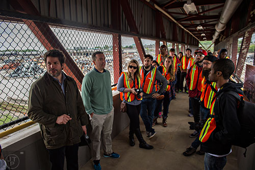 Jacob Vallo (left) talks to photographers  during a #weloveatl photowalk of the General Motors assembly plant in Doraville on Sunday, April 12, 2015. 