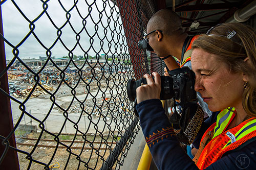 Kristin Bowen (right) and Adam Reid take photographs during a #weloveatl photowalk of the General Motors assembly plant in Doraville on Sunday, April 12, 2015. 