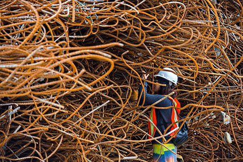 Eesl Kim takes a photograph of a pile of rebar that is set to be recycled during a #weloveatl photowalk of the General Motors assembly plant in Doraville on Sunday, April 12, 2015. 