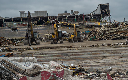 Heavy machinery sits in front of piles of rubble and a half demolished building during a #weloveatl photowalk of the General Motors assembly plant in Doraville on Sunday, April 12, 2015.