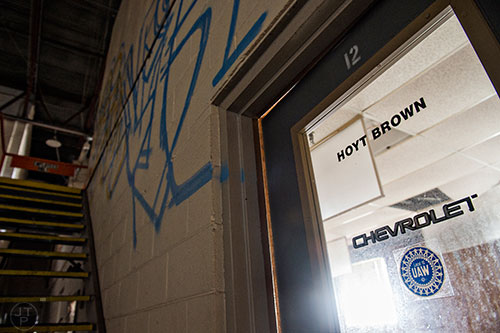 A Chevrolet sticker remains on an office door in one of the buildings inside the General Motors assembly plant in Doraville during a #weloveatl photowalk on Sunday, April 12, 2015. 