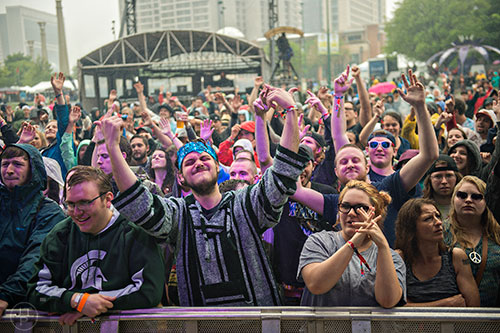 Kevin Layhe (center) dances as Aer performs on stage during the SweetWater 420 Fest at Centennial Olympic Park in Atlanta on Friday, April 17, 2015. 