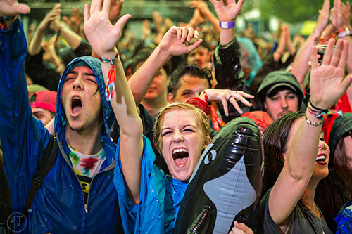 Morgan Allgaier (center) cheers as Beats Antique performs on stage during the SweetWater 420 Fest at Centennial Olympic Park in Atlanta on Friday, April 17, 2015. 