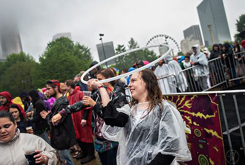Natalka Tyniec (center) spins a hula hoop over her head as Beats Antique performs on stage during the SweetWater 420 Fest at Centennial Olympic Park in Atlanta on Friday, April 17, 2015. 