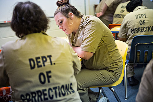 Amanda Momin (center) works on math problems during a tutoring session at the Lee Arrendale Correctional Facility in Alto on Friday, April 10, 2015. 