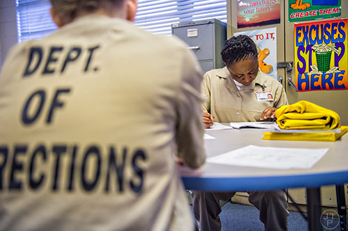 Ivy Champion (right) works on math problems during a tutoring session at the Lee Arrendale Correctional Facility in Alto on Friday, April 10, 2015. 