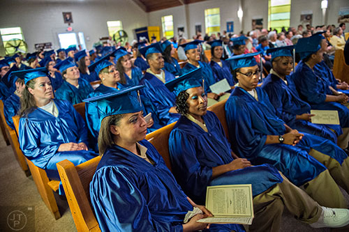 Courtnee Cunningham (front left) waits to receive her certificate during the graduation ceremony for theological studies at the Lee Arrendale Correctional Facility in Alto on Friday, April 10, 2015. 